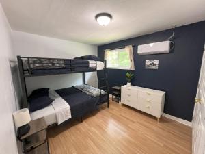 a bedroom with two bunk beds and a desk at Bluebird Liberty Cottage in Saint Robert