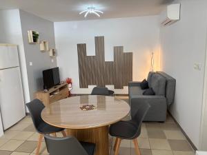 a living room with a table and a couch at gite chez Galinette in Nissan-lez-Enserune