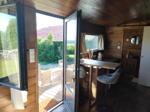 a small room with a desk and a glass door at Tiny escapade in Dombasle-devant-Darney