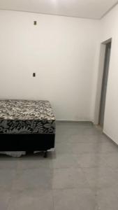 a bedroom with a bed in a white room at Rancho Velho Chico in Canindé de São Francisco