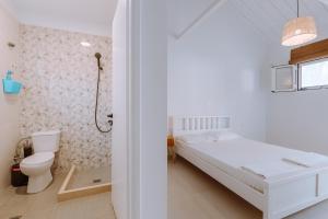 a white bedroom with a bed and a shower at Burano Camping Beach-Bar in Néa Thésis +215 photos