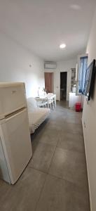 a living room with a bed and a refrigerator at Casa Vacanze RosMary in Agropoli