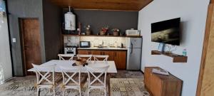 a kitchen with a table and chairs in a kitchen at Dorrego Loft in Barraquero