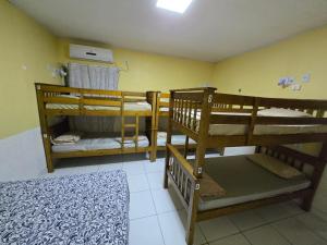 a room with three bunk beds and a bed at Pousada Hostel Mar e Sertão in Maceió