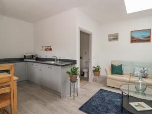 une cuisine et un salon avec un canapé dans l'établissement Bathach Mor, à Oban