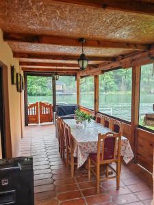 a dining room with a table and some chairs at Ambijent house Patrijaha Pavla 22 in Železnička Stanica Ovčar Banja