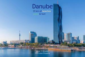 a view of a city with a river and buildings at Discover Danube and Prater Stern from Our 1BR Gem in Vienna