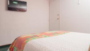 Postel nebo postele na pokoji v ubytování Innovar Casa Hostal