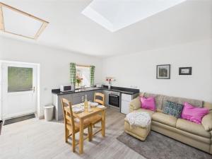 a living room with a couch and a table at Bathach Beag in Oban