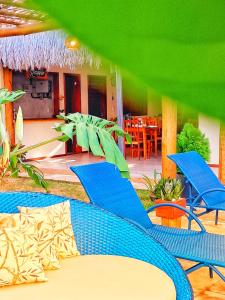 a group of blue chairs and tables in a room at Pousada Canaã Icaraizinho in Amontada +53 photos