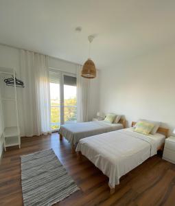 a bedroom with two beds and a large window at Peaceful Holiday Villas-Pomegranate-3 bathrooms-Private pool in Belek