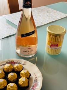 a bottle of wine next to a plate of peanut butter cookies at Chez Schumi in Kirchheim +18 photos