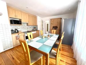 a kitchen with a table and chairs in a room at Chez Schumi in Kirchheim