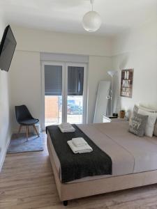 a white bedroom with a large bed and a chair at Feel like your home modern apartment next to expo in Montijo +41 photos
