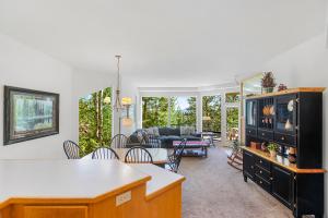 a kitchen and living room with a table and chairs at Frosty Summit Condo at Mount Bachelor Village Resort with Pool and Hot Tub in Bend