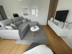 a living room with a couch and a tv at Ferienwohnung Steubenhöft in Cuxhaven
