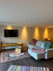 a living room with a couch and a flat screen tv at SweetHome in Birkenau