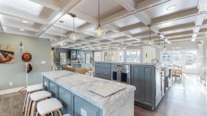 a large kitchen with blue cabinets and a large island at The Bluegrass Grand Estate: Bourbon Trail Luxury in Bardstown