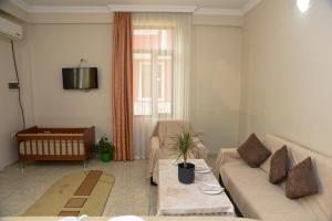 a living room with a couch and a table at Hello Batumi Apartment in Batumi +25 photos