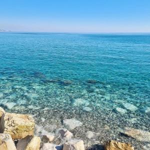 a large body of water with rocks and clear water at La 34 Tiny House with sunny terrace in Menton