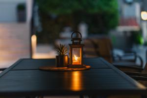 a lantern sitting on a table with a potted plant at Villa Oleander in Ulcinj