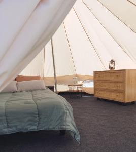 a bedroom with a bed in a tent at La tente de l'atelier de la Gare in Sigournais