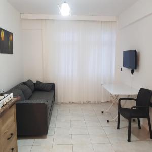 a living room with a couch and a table at Fethiye Apart Otel in Fethiye