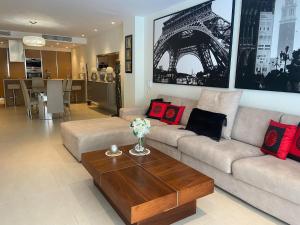 a living room with a couch and a coffee table at Luxurious 3 Bedroom with POOL in St. Julianʼs