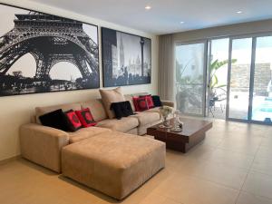a living room with a couch and a table at Luxurious 3 Bedroom with POOL in St. Julianʼs