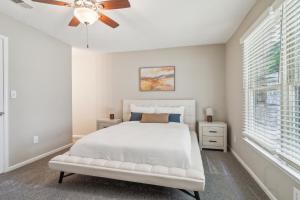 a white bedroom with a bed and a ceiling fan at Rex Townhomes 2401a I Comfy 2 Bed 2 Bath in Ellenwood +18 photos