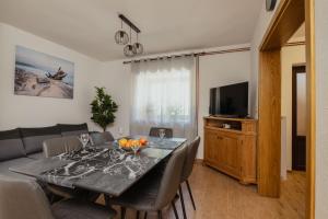 a dining room with a table and a couch at Kuća za odmor Roko in Sveti Rok