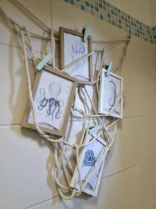 a group of framed pictures hanging on a wall at Appartamento le vele in Cecina