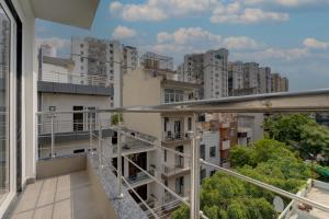 an apartment balcony with a view of buildings at Aura Homes 1 BHK Serviced Apartment Near Golf Course Road Gurgaon in Gurgaon