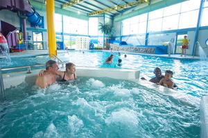 a group of people in a swimming pool at Peaceful Seaside Getaway in Mainsriddle