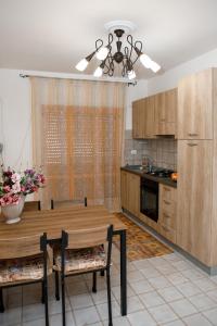 a kitchen with a wooden table and a dining room at Appartamento Stefano in Scalea