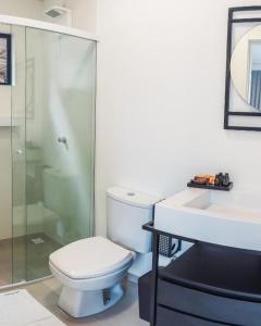 a bathroom with a toilet and a shower and a sink at Loft Bamberg 201-Pomerode in Pomerode