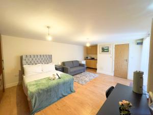 a bedroom with a bed and a living room at Heathrow Lodge BnB in Harmondsworth