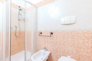 a bathroom with a shower and a toilet and a sink at Strepitoso Bilocale Via Mosca Olbia in Olbia