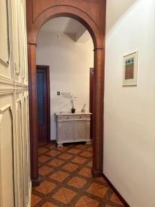 a hallway with an archway and a table in a room at Livorno Life in Livorno +28 photos