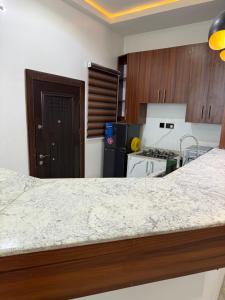 a kitchen with a counter top and a stove top oven at Napoleons Nest - Terravista Apartments in Abuja