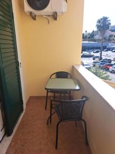 a small balcony with a table and two chairs at Casa Barbara in Lagos