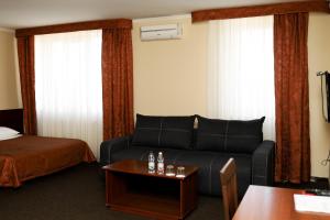 a hotel room with a couch and a bed at Belveder in Rohatyn +53 photos