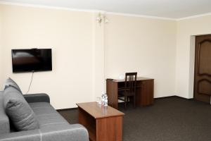 a living room with a couch and a table at Belveder in Rohatyn