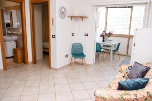 a living room with a couch and a table at Appartamento LUX in Scalea +11 photos
