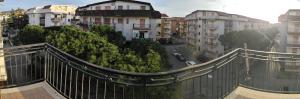 a view of a city from a balcony with buildings at Appartamento LUX in Scalea
