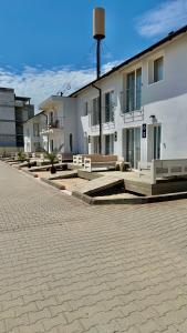 a building with a lot of benches in front of it at Vila Plaja Azur in Eforie Nord +64 photos