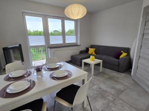 a living room with a white table and chairs at Parkcity Ustroń in Ustroń