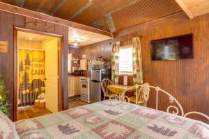 a room with a bed and a table and a kitchen at Romantic Escape in Greers Ferry Less Than 1 Mi to Lake in Higden +21 photos