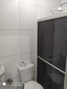 a bathroom with a toilet and a glass shower at Pousada guarany acesso aos quartos apenas por escadas in Campina Grande