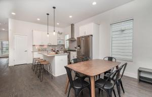 a kitchen and dining room with a table and chairs at Double Time - Ping-Pong Table - Mins to Germantown in Nashville